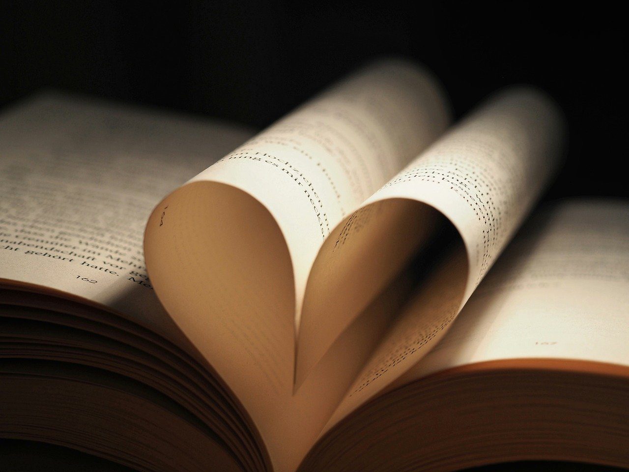 A book with pages folded into a heart shape, symbolizing stress-free and enjoyable exam preparation.
